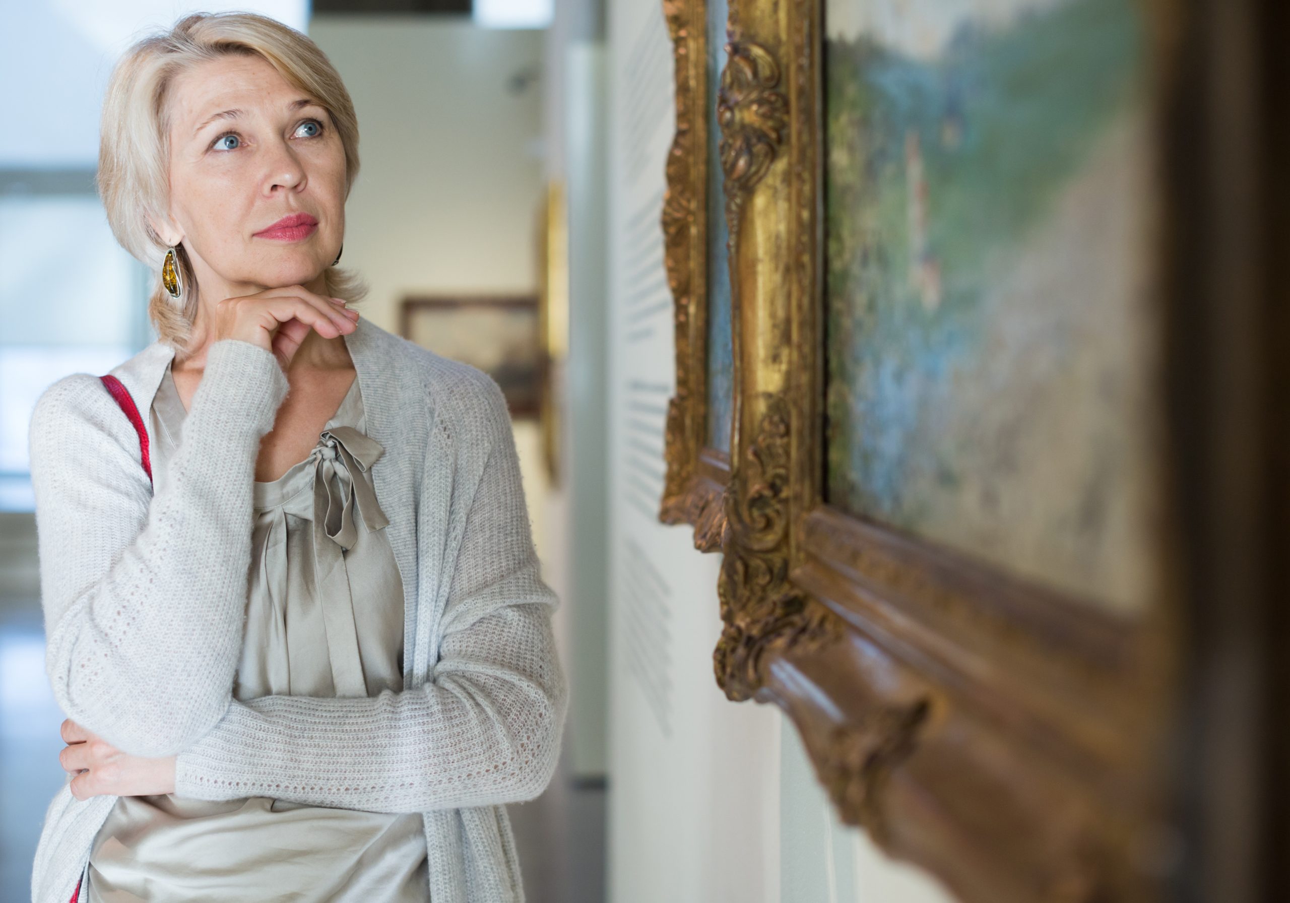 Portrait of adult woman near picture collection