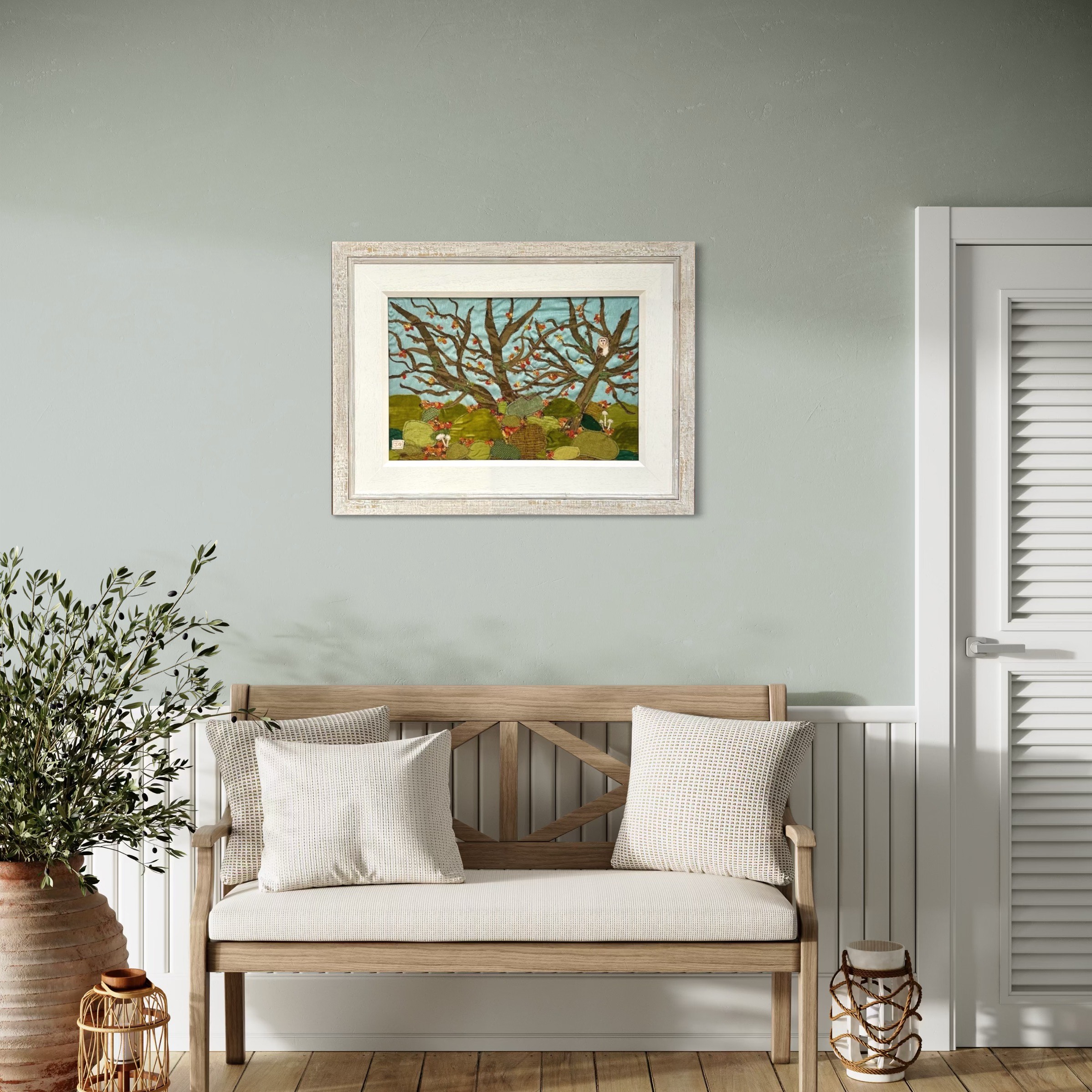 Textile art of a woodland with boulders and an owl, by Jackie Gale, available through Wildwood Art Gallery